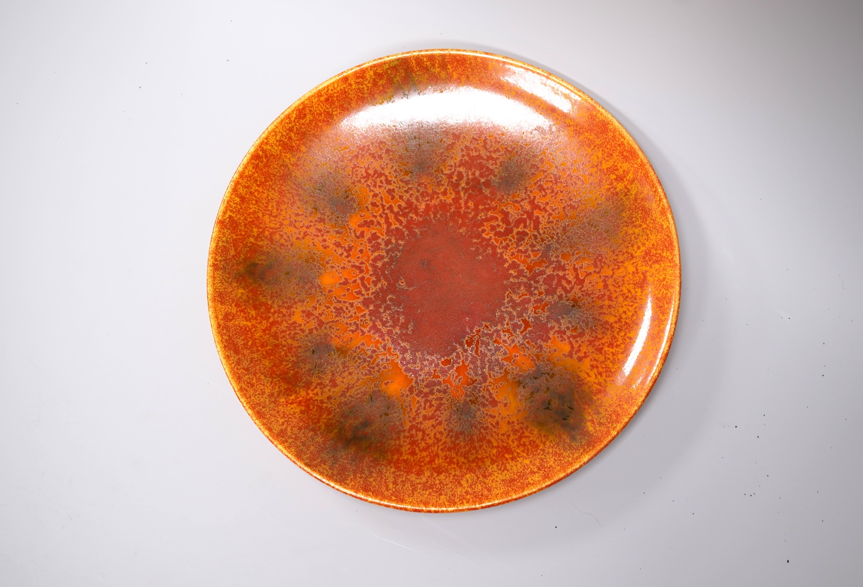 A Pilkingtons orange lustre plate, stamped to the base, 21cm in diameter